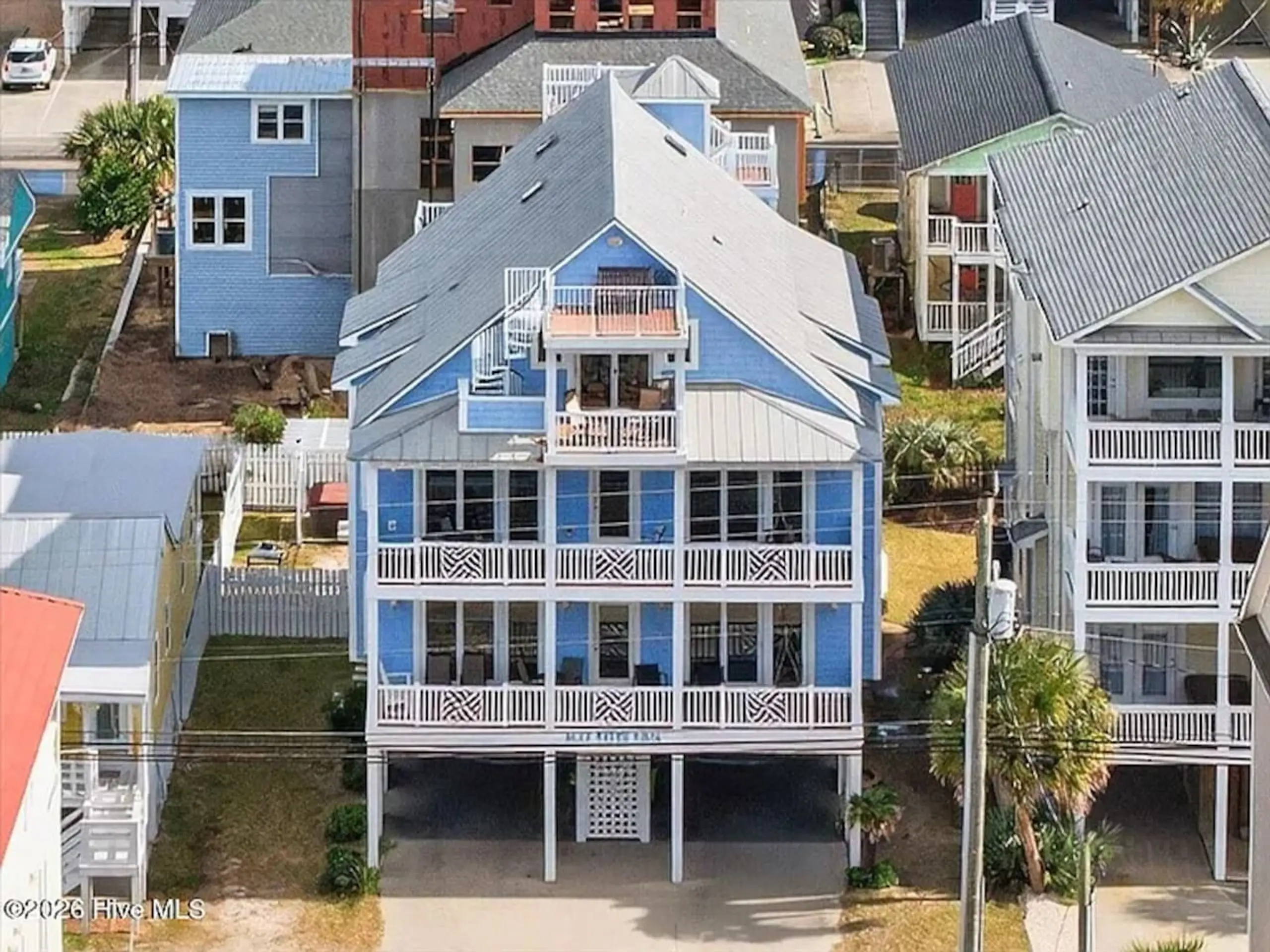 Three-story blue beach house on stilts