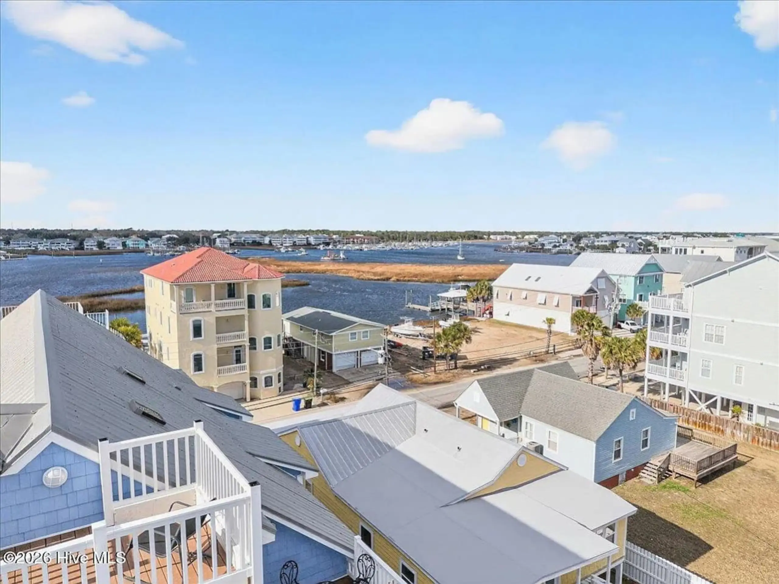 Aerial view of colorful beach houses by bay