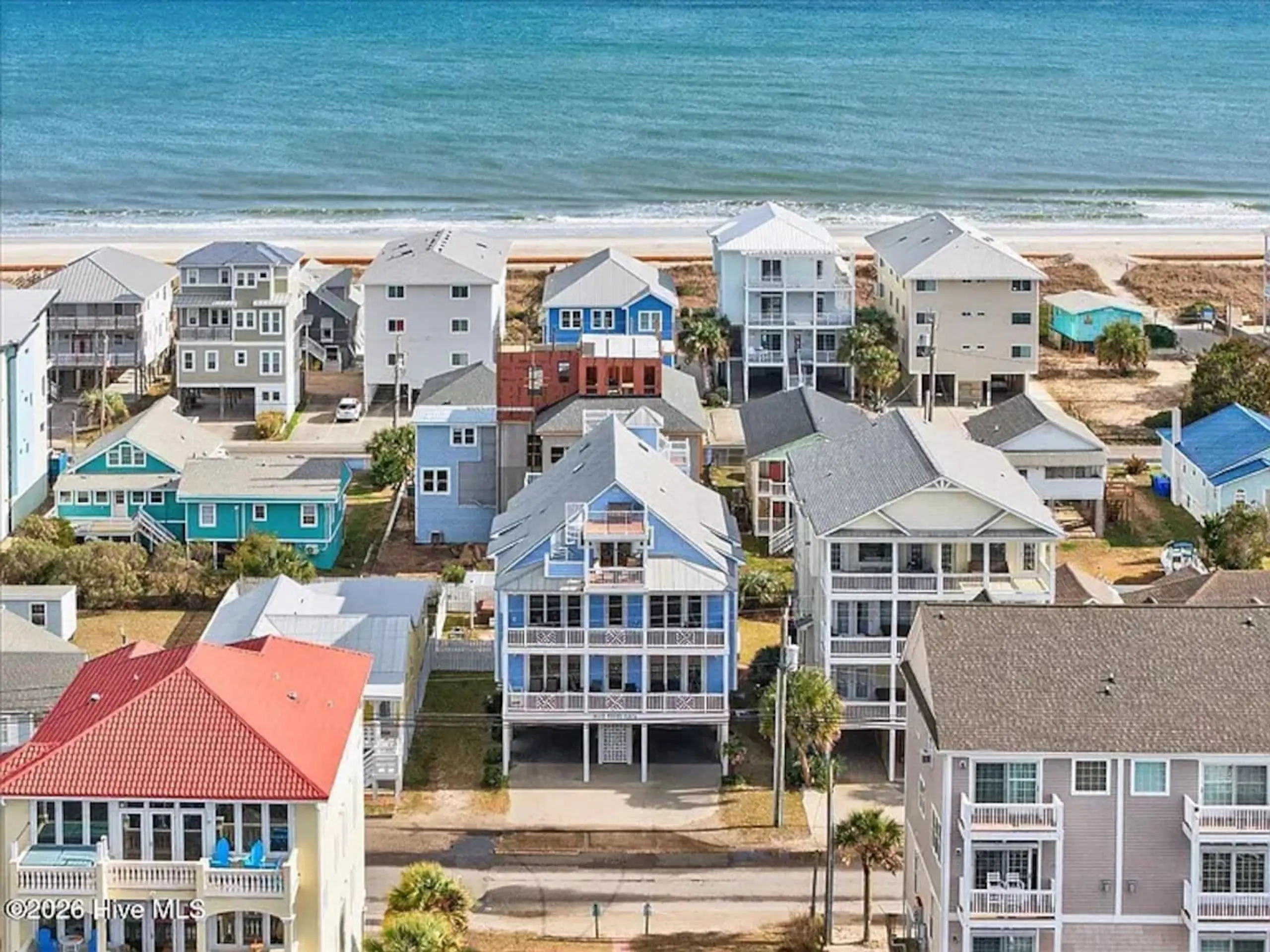 Aerial view of colorful beachfront houses by ocean