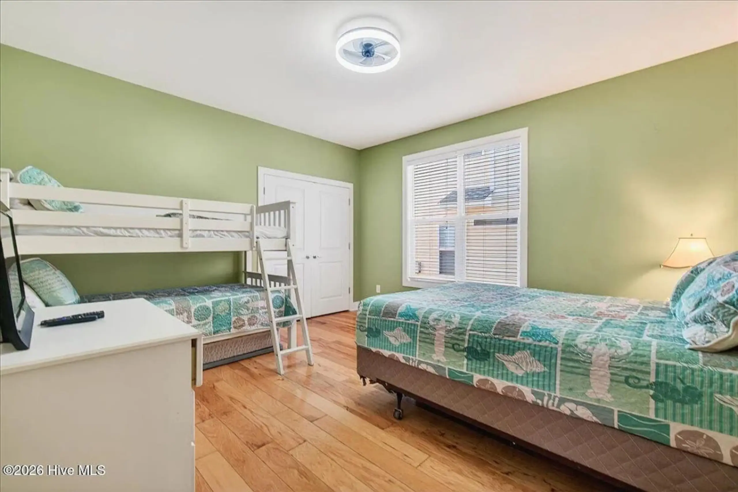 Green bedroom with bunk and single beds