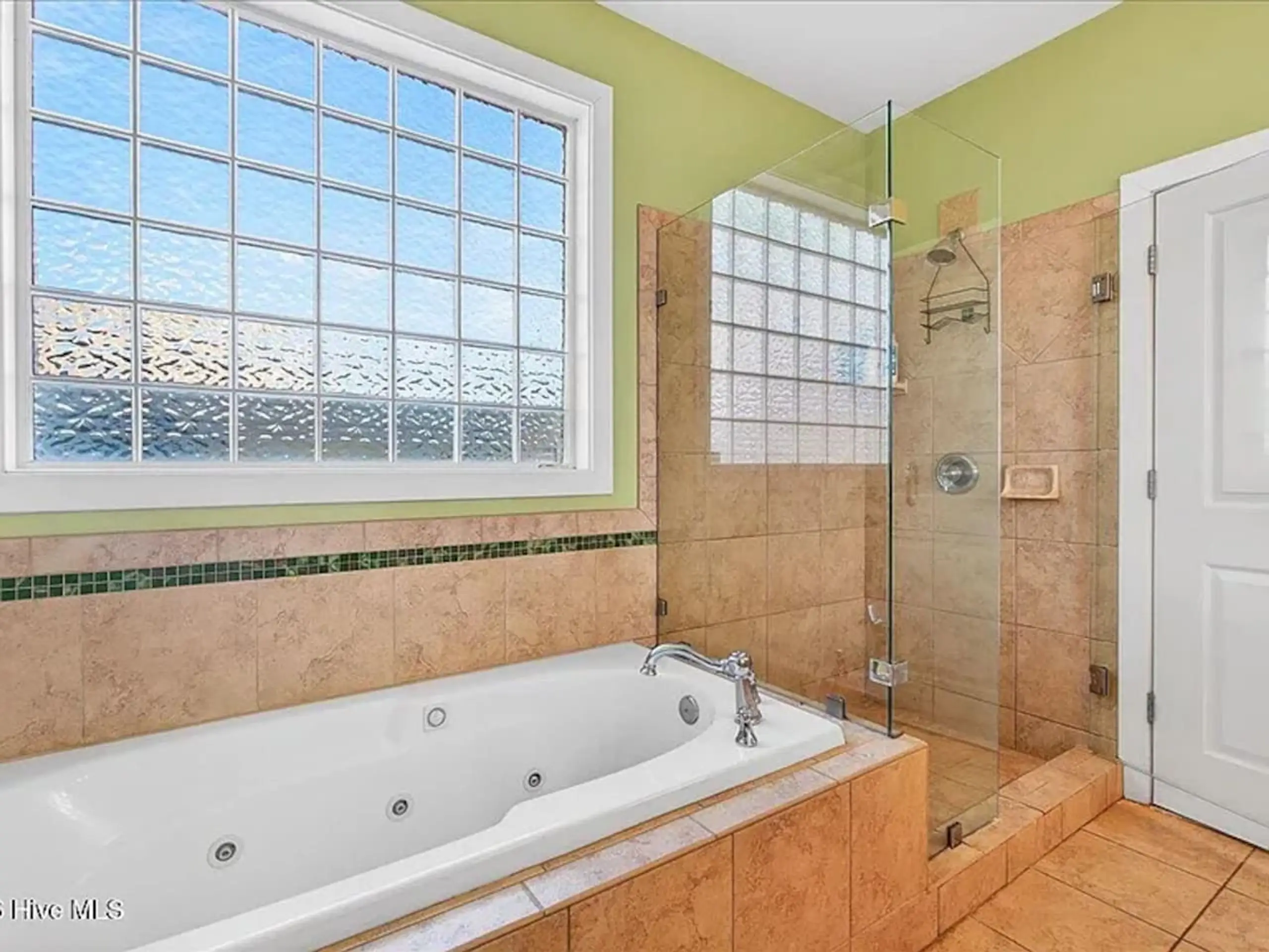 Bathroom with jetted tub and glass shower