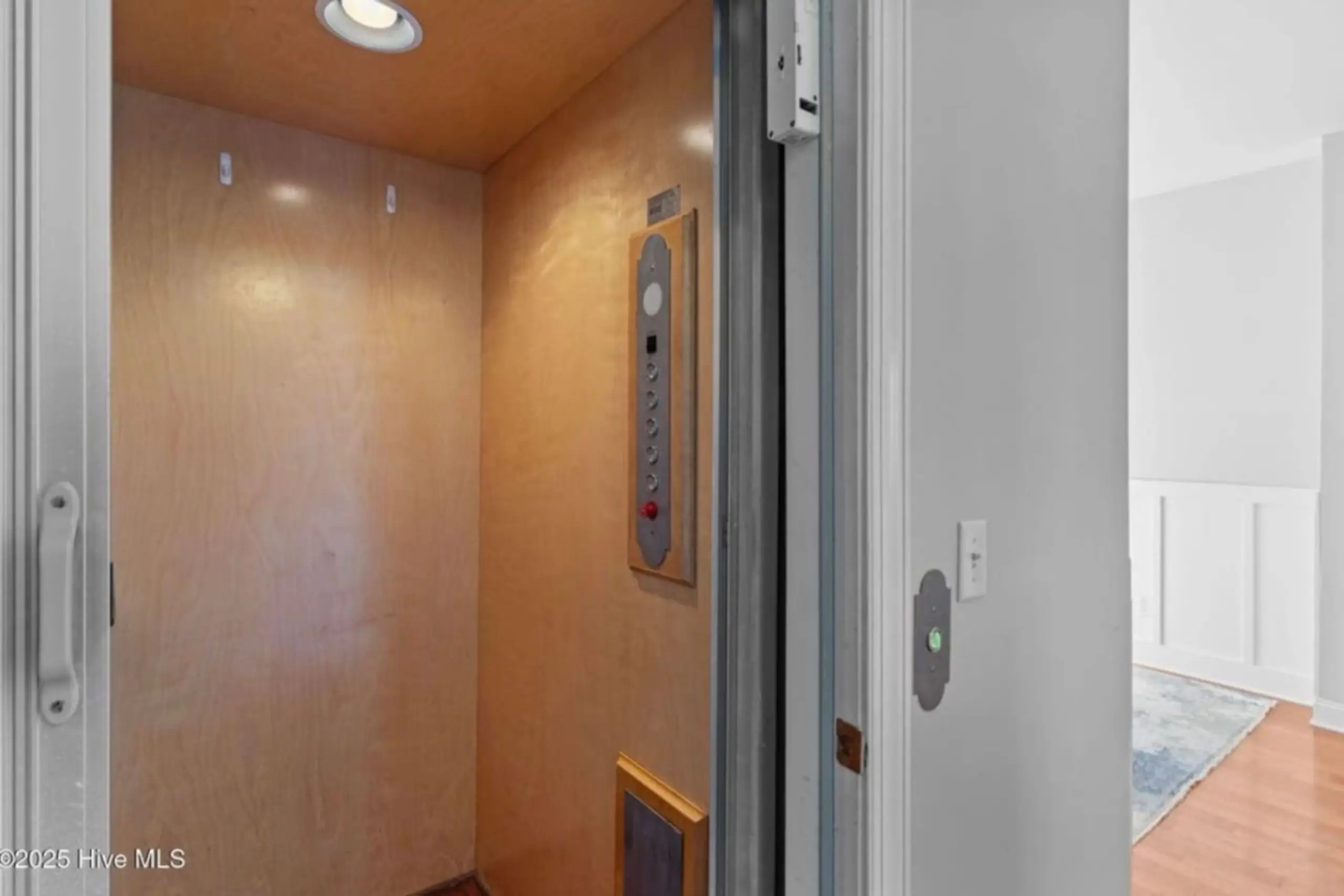 Home elevator with wood interior, open door