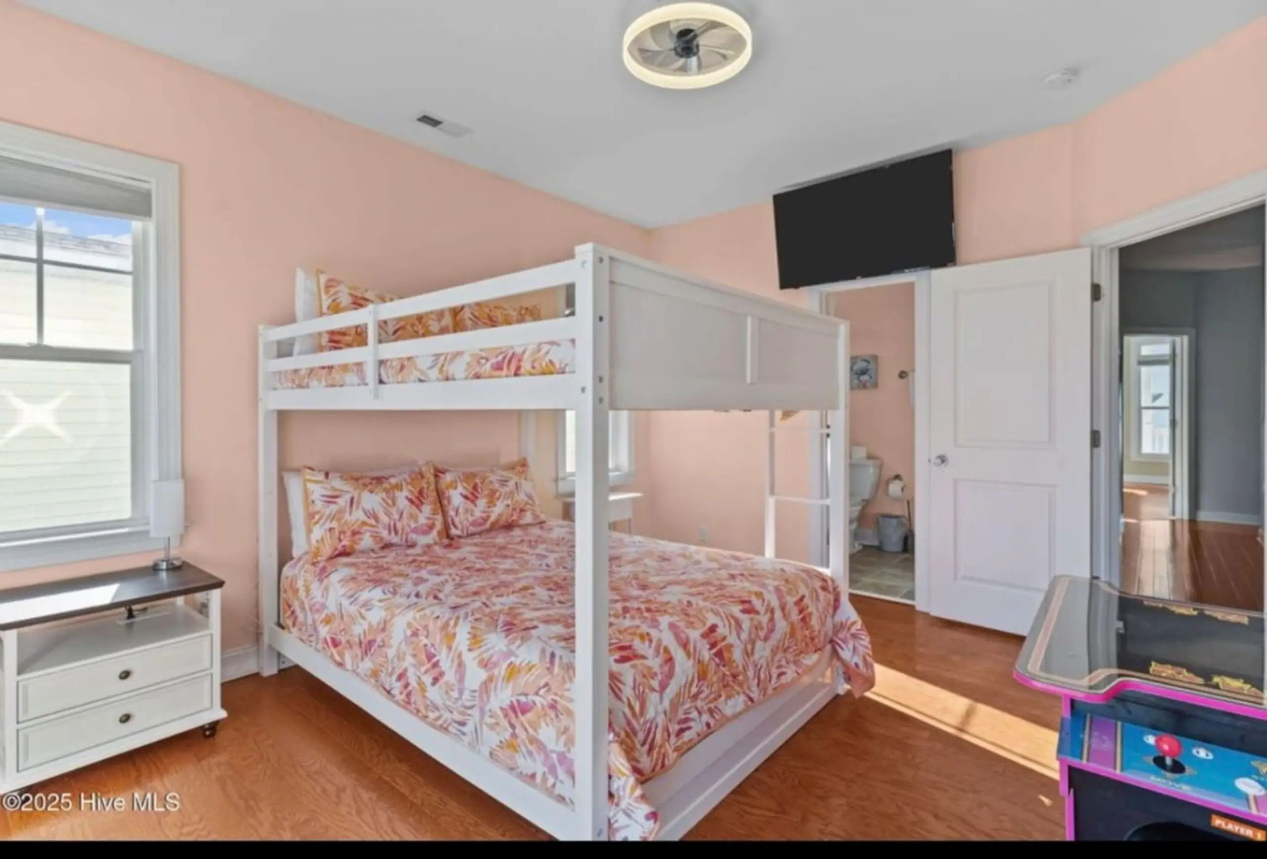 Pink bedroom with white bunk bed