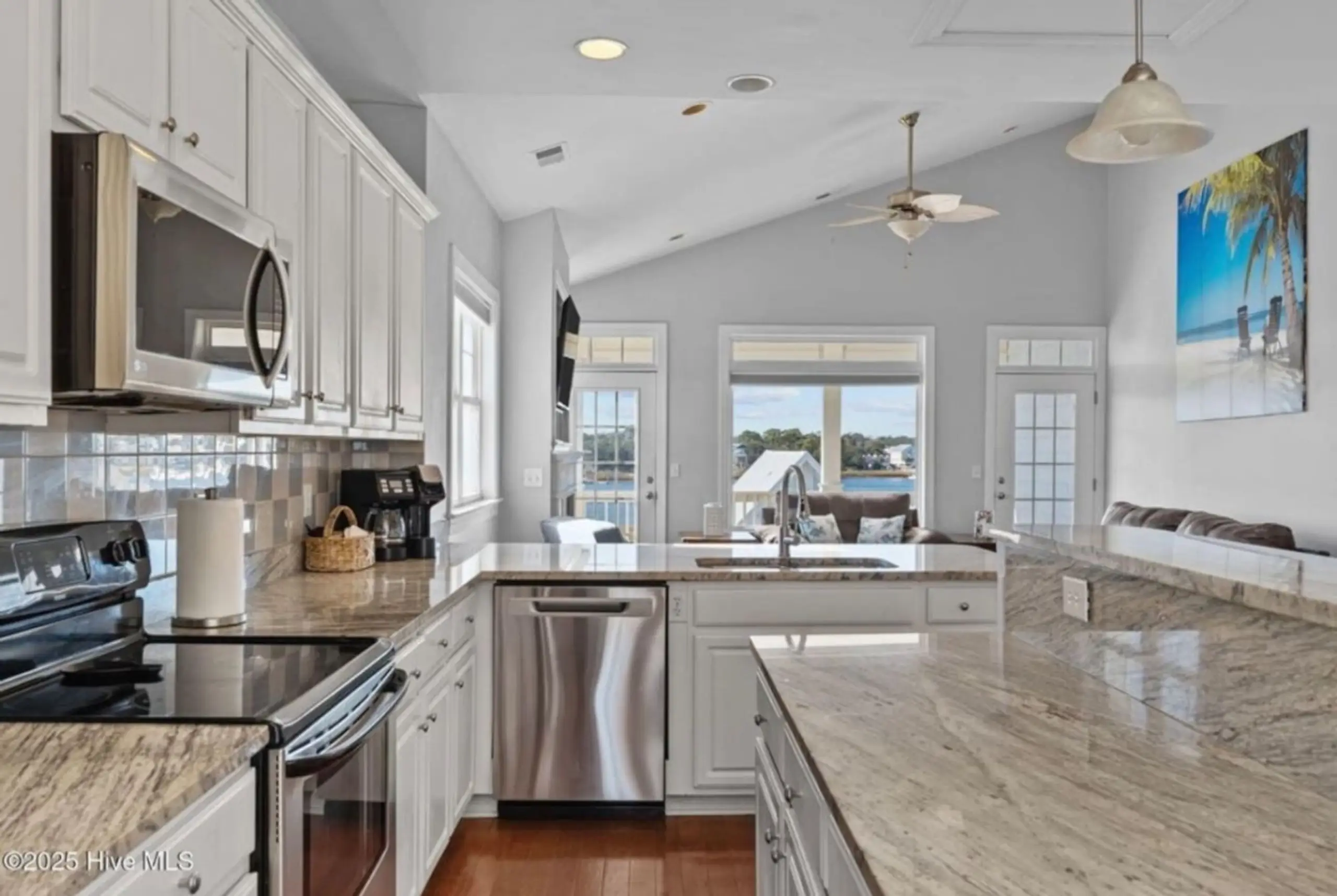 Bright waterfront kitchen with marble island