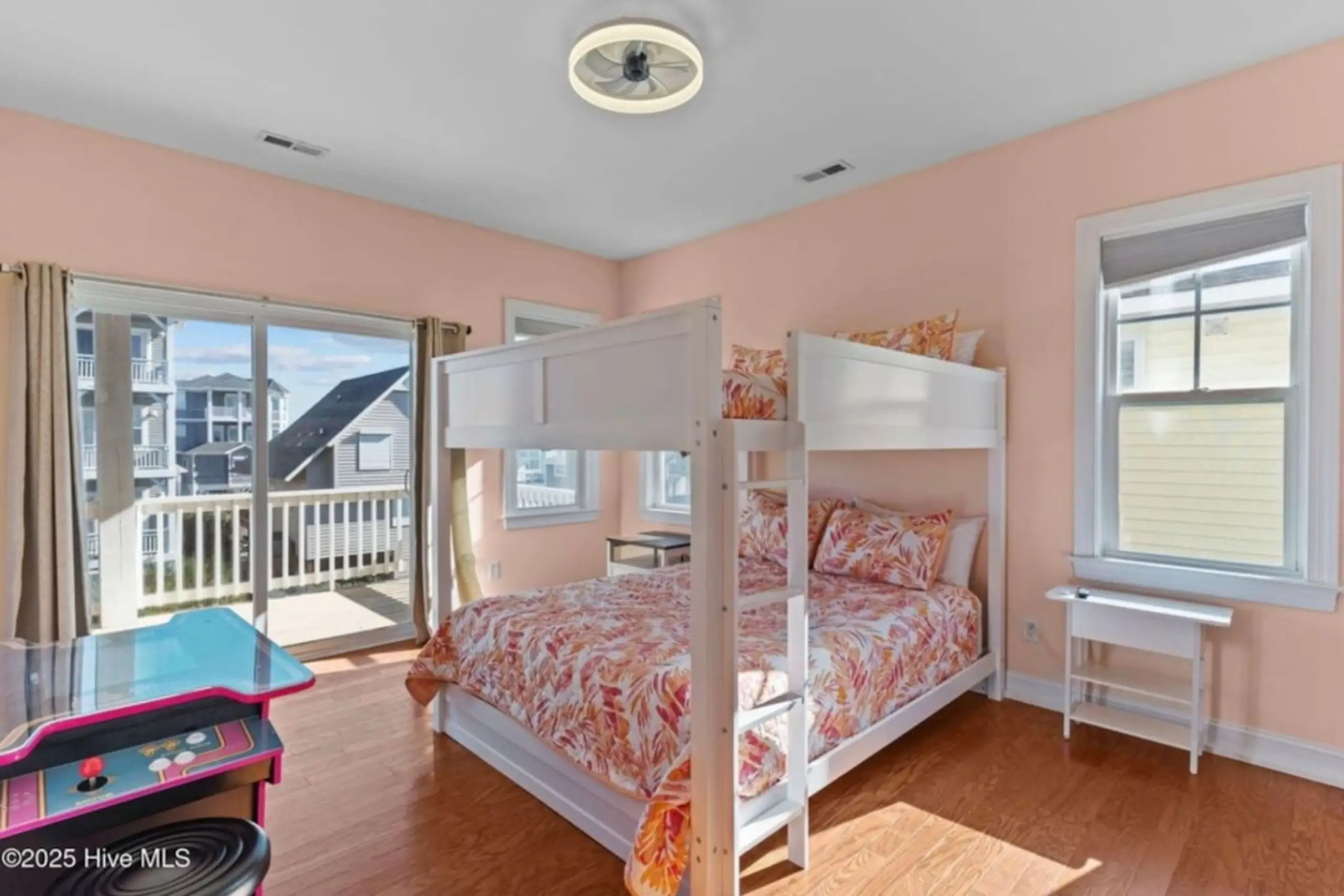 Bright pink bedroom with white bunk bed
