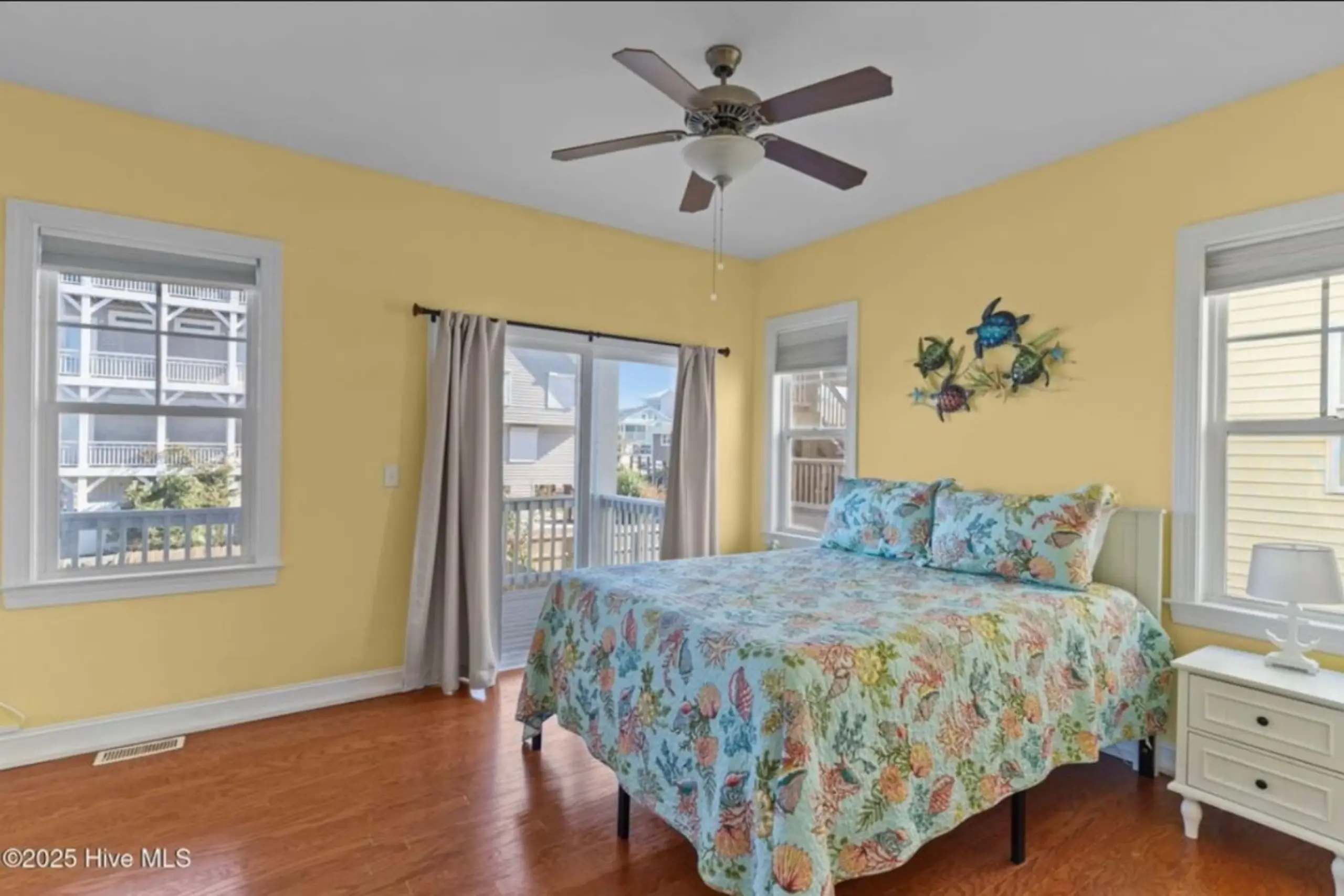 Sunny coastal bedroom with floral bedspread