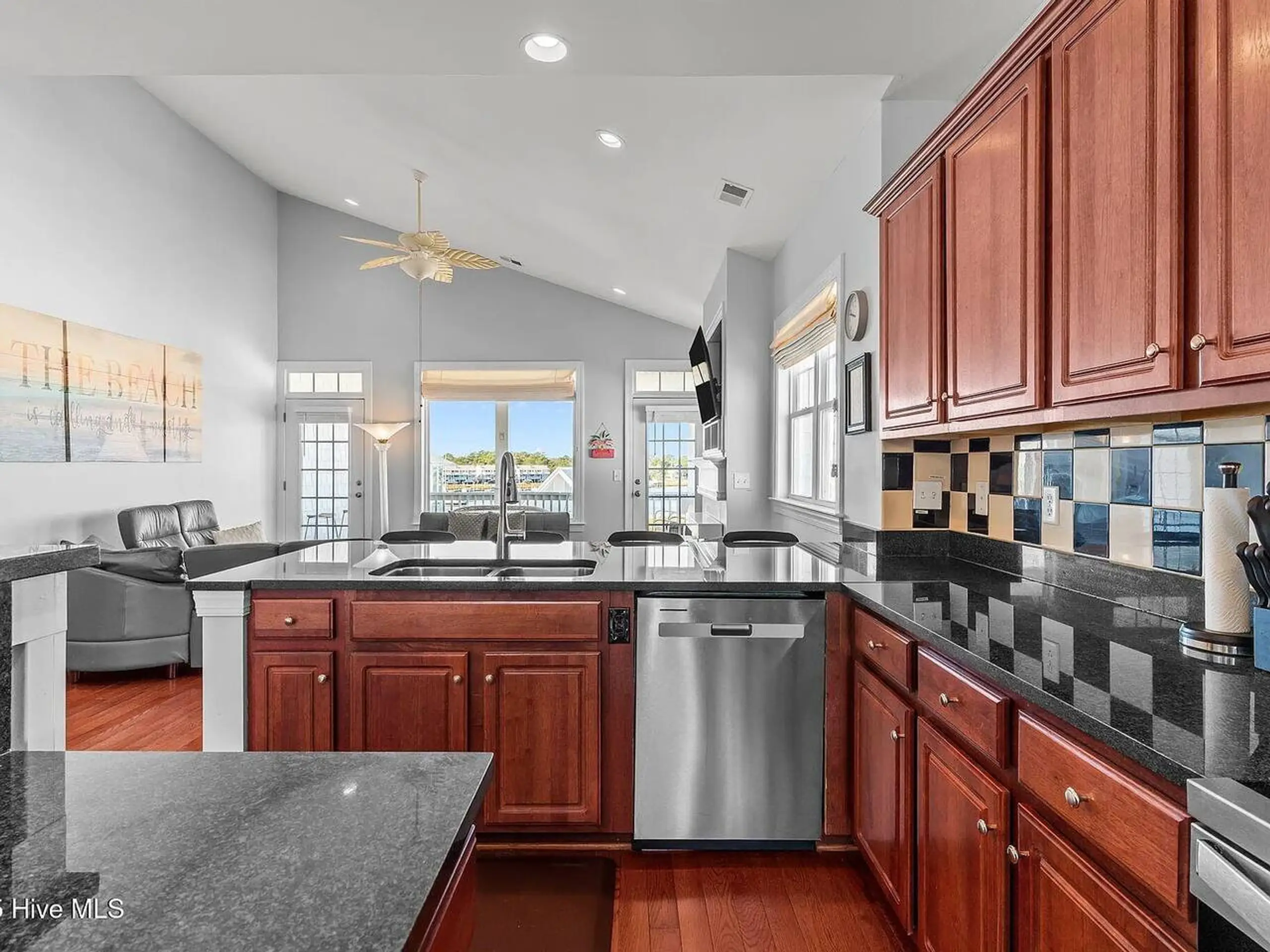 Open kitchen with cherry cabinets and waterfront view