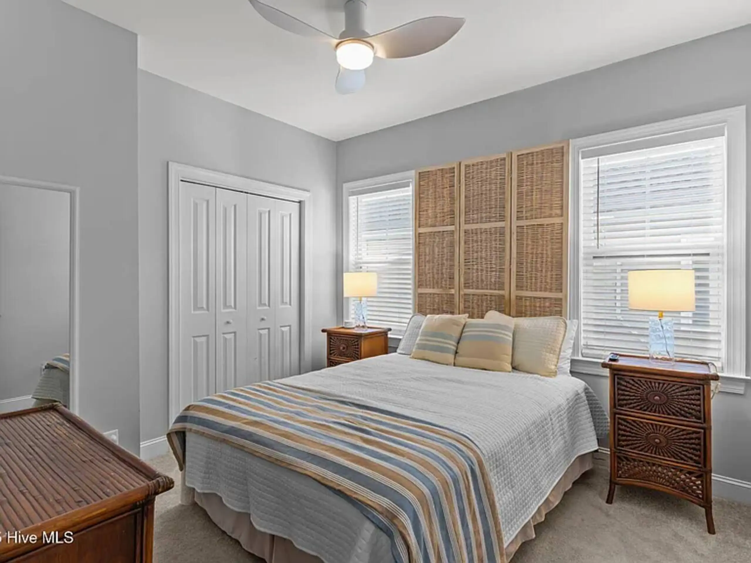 Cozy bedroom with striped bedding and wicker headboard