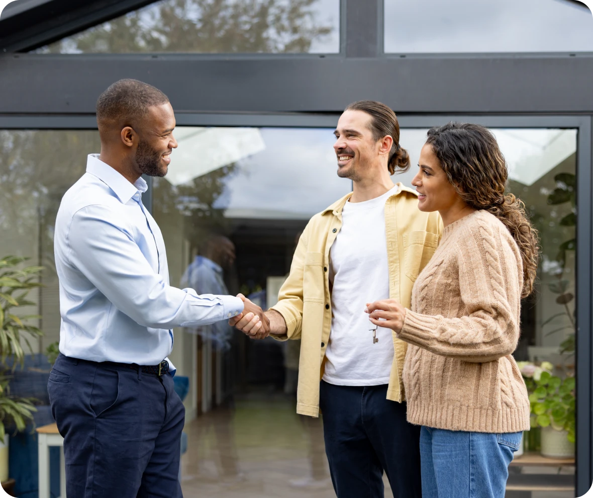 Friendly handshake between three people