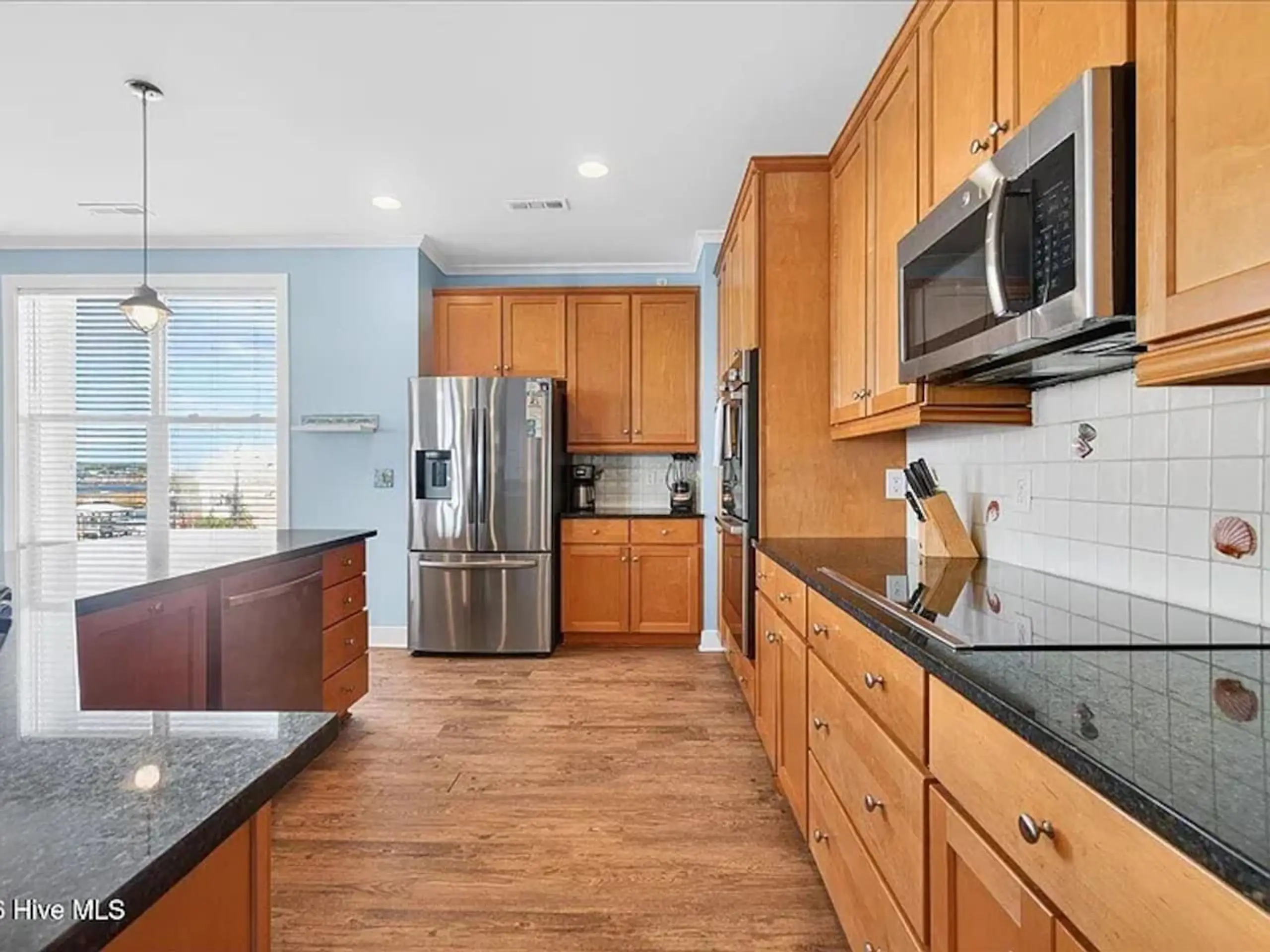 Kitchen with wooden cabinets, granite countertops, stainless appliances