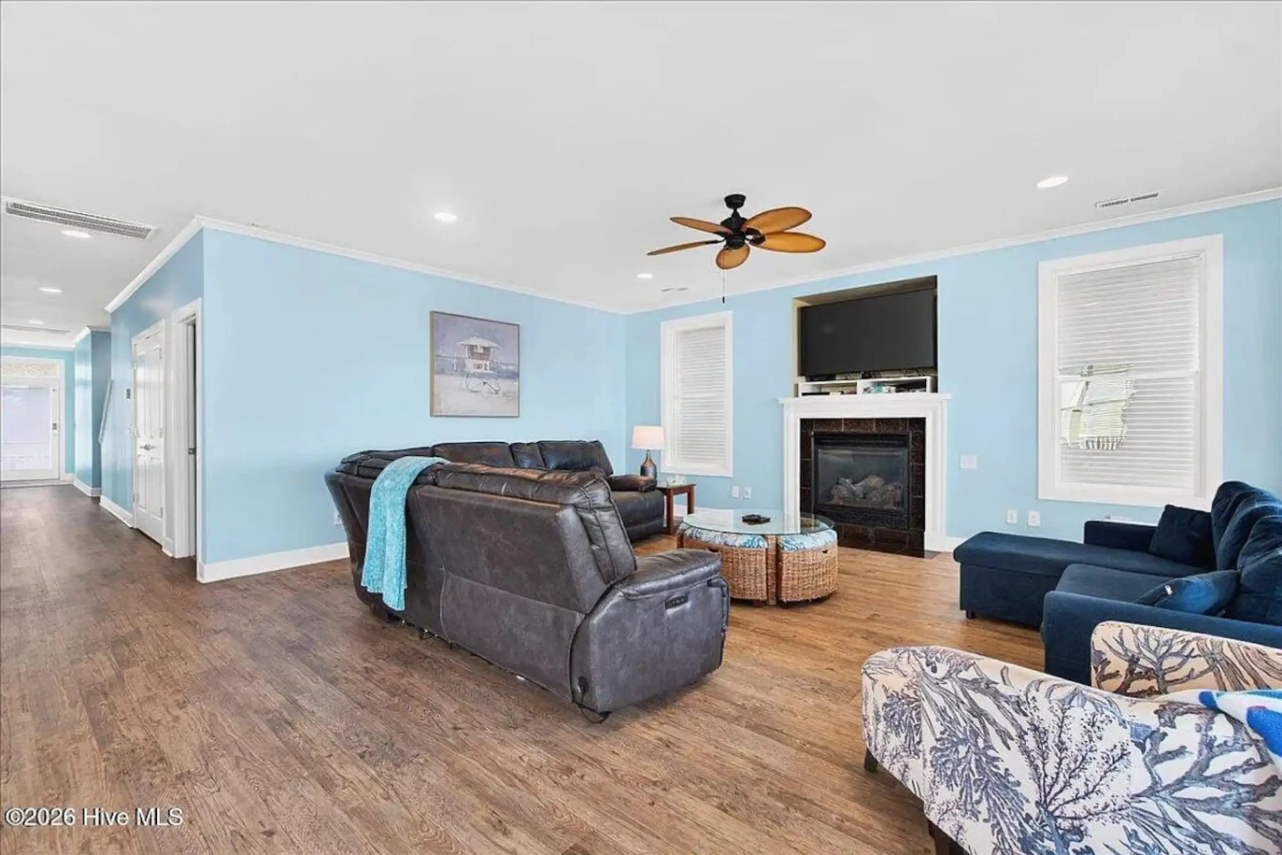 Blue living room with sectional, fireplace, fan