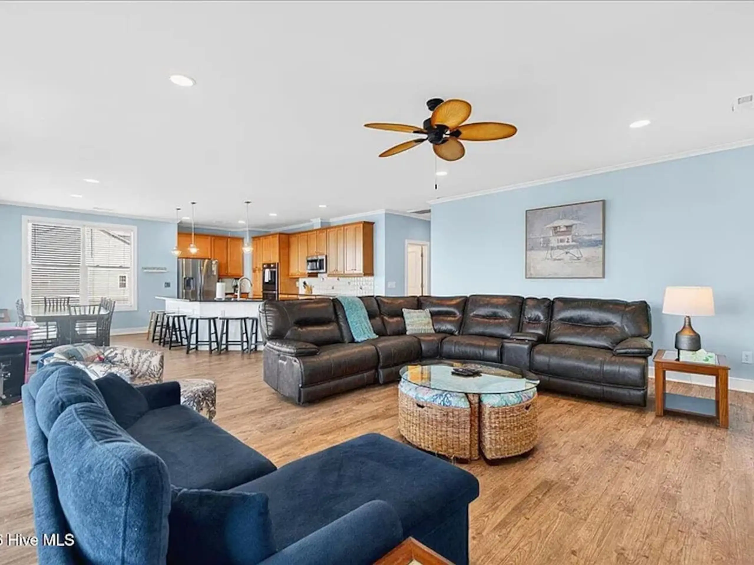 Open living room and kitchen with leather sectional