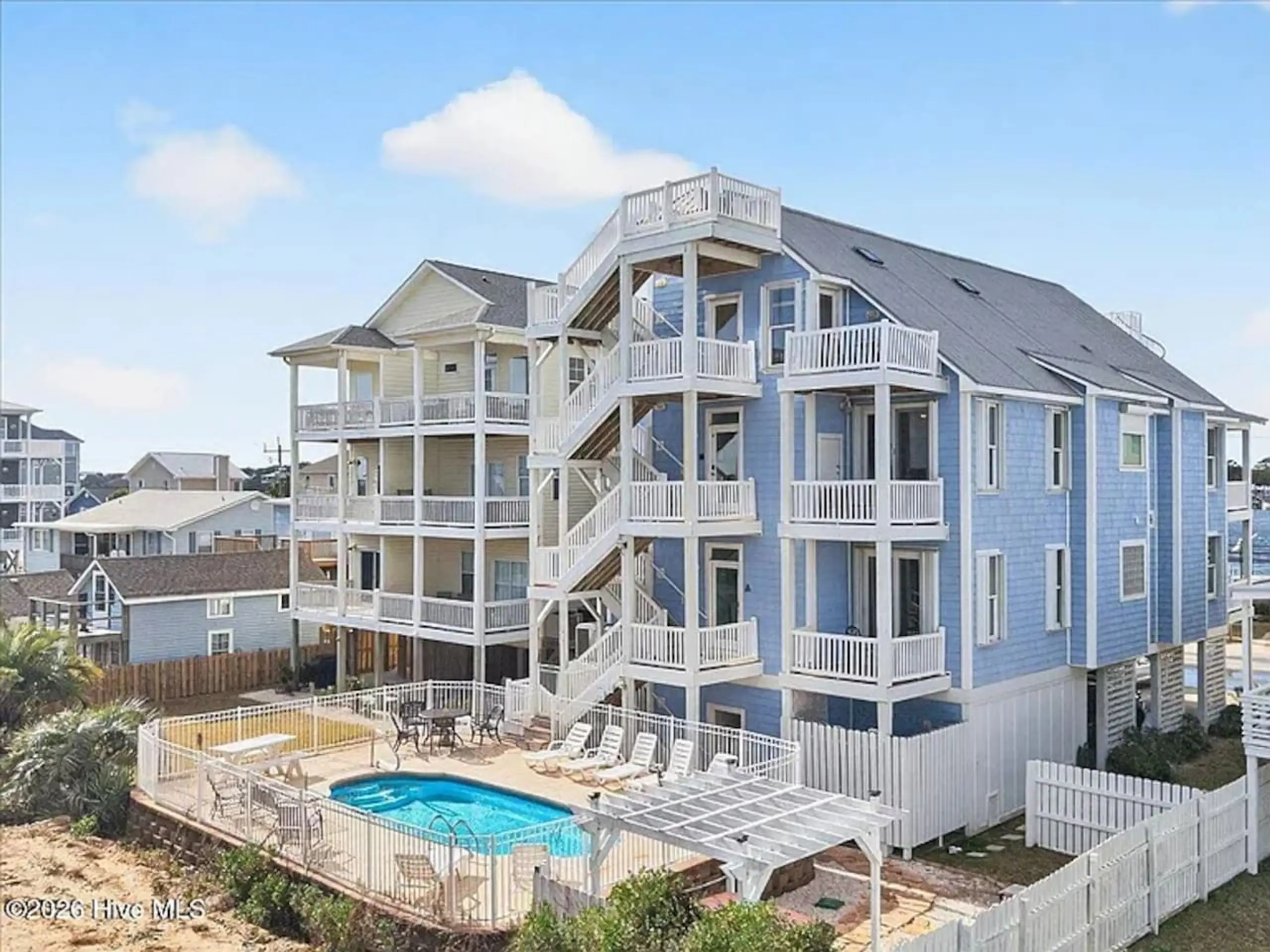 Blue multi-story beach house with pool